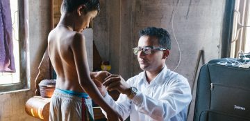 Arts onderzoekt een kind op symptomen van lepra                
