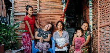 Nepalese familie op het stoepje voor hun huis                